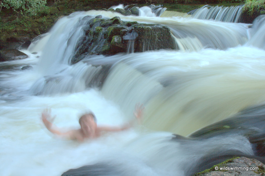 A man swimming in the fast-flowing waters of Salmon Leaps.