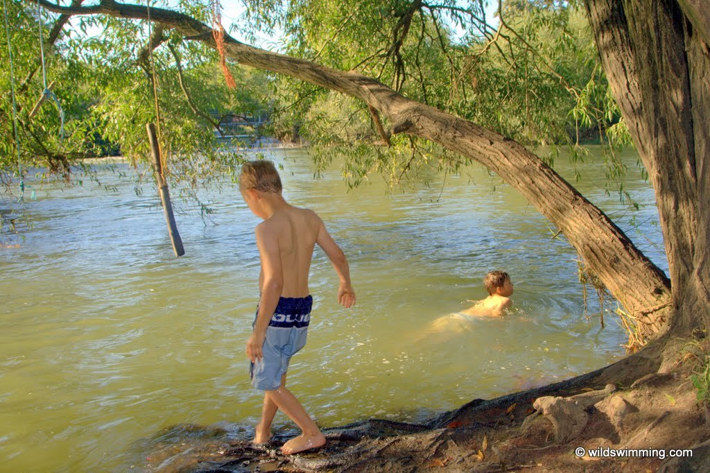 A boy ready to get into the River Thames at Lechlade.